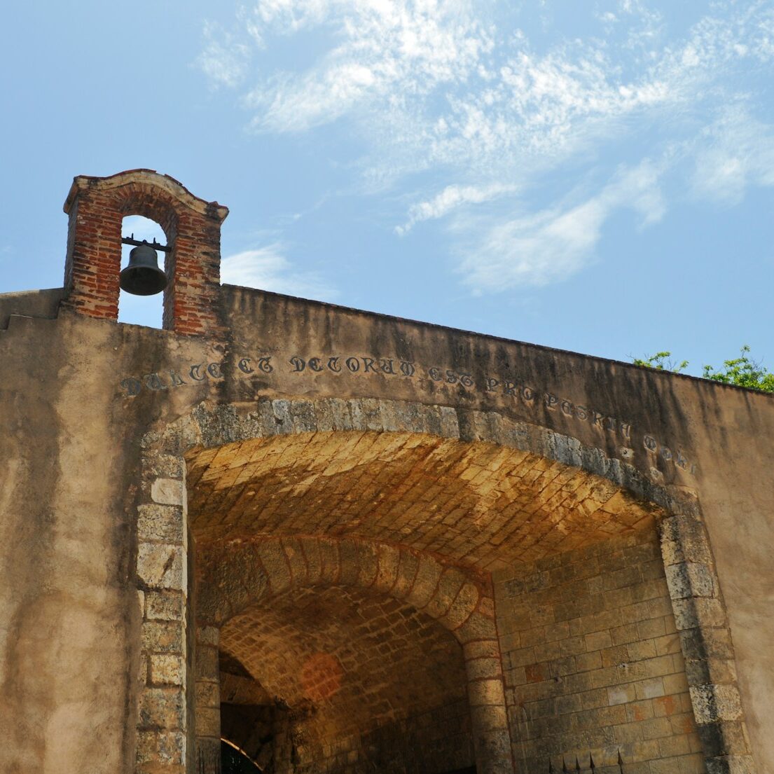 an old building with a bell on the top of it